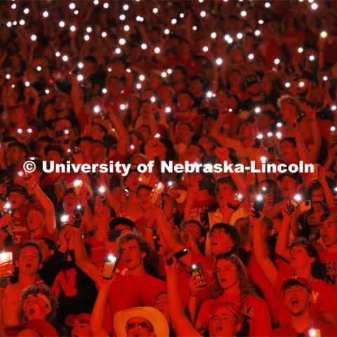 Fans illuminate a darkened stadium with their phone lights at the Nebraska vs. Illinois football game. September 20, 2024. Photo by Craig Chandler / University Communication and Marketing.