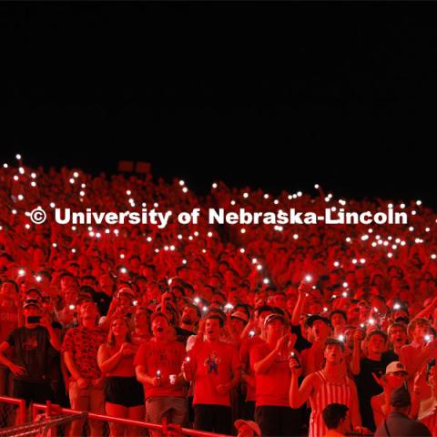 Fans illuminate a darkened stadium with their phone lights at the Nebraska vs. Illinois football game. September 20, 2024. Photo by Craig Chandler / University Communication and Marketing.