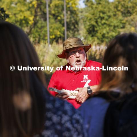 David Wedin, Director of the Grassland Studies Center and Professor in the School of Natural Resources, discusses various jaw bones and teeth of prairie animals and he talks about how they survived on grasslands. Wedin paneled off an area of the prairie grasses north of Hardin Hall and brought in four head of cattle. The cattle were part of an outdoor teaching lab for students including those in NRES220 Principles of Ecology. September 30, 2024. Photo by Craig Chandler / University Communication and Marketing.