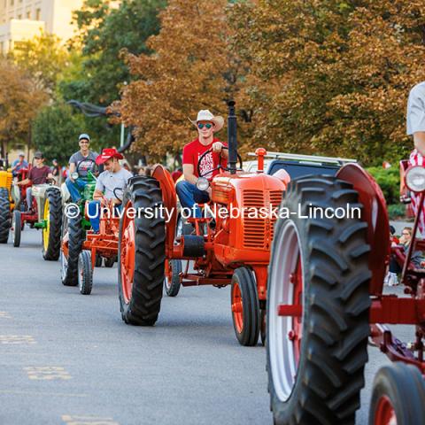 The Tractor Restoration Club participates in the 2024 Homecoming Parade with one member decked out in striped overalls and a corn head hat. October 4, 2024. Photo by Kristen Labadie / University Communication.