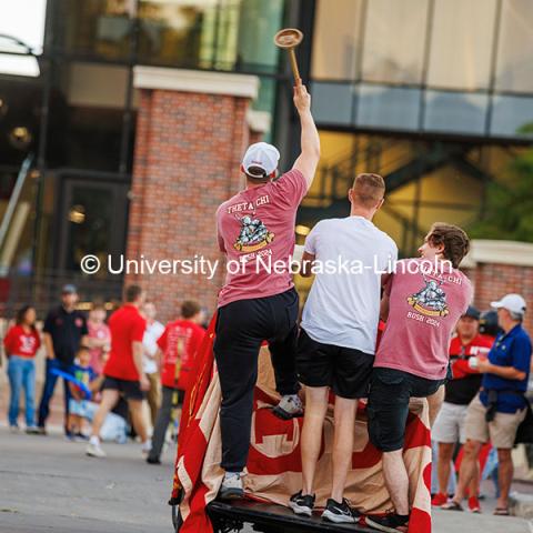 The Theta Chi Fraternity members wave a toilet plunger as the ride on their float at the 2024 Homecoming Parade. October 4, 2024. Photo by Kristen Labadie / University Communication.