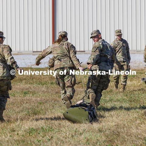 UNL cadet Max Holstrom looks back at a “wounded” soldier as the cadets pull a cadet on a sled to simulate helping and moving a wounded soldier. ROTC cadets on fall exercise. October 4, 2024. Photo by Craig Chandler / University Communication and Marketing.