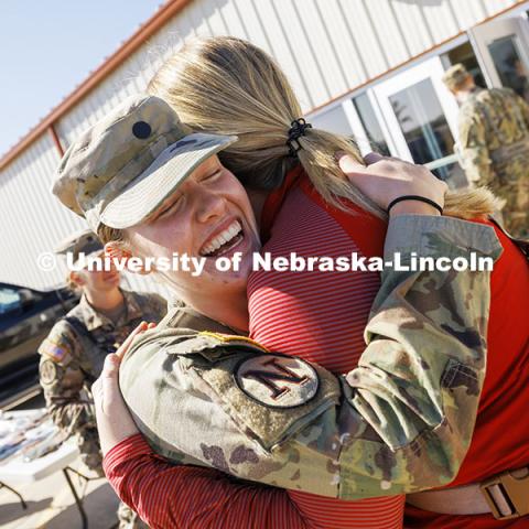 Cadet Natalie Karrels, a senior in supply chain management, hugs Erin Burnette, director of the Nebraska Business Honors Academy, between ROTC exercises. Karrels nominated Burnette to participate in the Army ROTC flight. ROTC cadets on fall exercise. October 4, 2024. Photo by Craig Chandler / University Communication and Marketing.