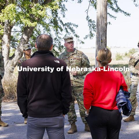 Lt. Col. Tom Slykhuis talks to the professors and staff members as cadets, from left, Joe Wiese, Alyssa Batista and Colten Stevens listen. ROTC cadets on fall exercise. October 4, 2024. Photo by Craig Chandler / University Communication and Marketing.