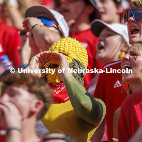 Ryan Jensen, a senior from Lincoln, wore his own version of a corn head knitted by his girlfriend, Emmy Oldham of Wellfleet, Nebraska. Jensen said it felt about 20 degrees hotter inside the headgear. Nebraska vs Rutgers football game. Homecoming game. October 5, 2024. Photo by Craig Chandler / University Communication and Marketing.