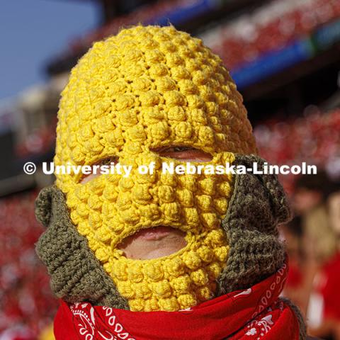 Ryan Jensen, a senior from Lincoln, wore his own version of a corn head knitted by his girlfriend, Emmy Oldham of Wellfleet, Nebraska. Jensen said it felt about 20 degrees hotter inside the headgear. Nebraska vs Rutgers football game. Homecoming game. October 5, 2024. Photo by Craig Chandler / University Communication and Marketing.