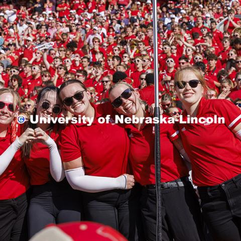 The Cornhusker Marching Band Color Guard pose for a picture at the Nebraska vs Rutgers football game. Homecoming game. October 5, 2024. Photo by Craig Chandler / University Communication and Marketing.