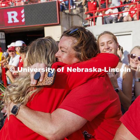 Homecoming royalty Emmerson Putnam receives a hug at the Nebraska vs Rutgers football game. Homecoming game. October 5, 2024. Photo by Craig Chandler / University Communication and Marketing.