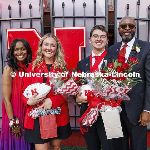 Homecoming royalty Emmerson Putnam, biological sciences major of Bellevue, Nebraska and Jaime Smith, a music education major of West Des Moines, Iowa, pose with Temple Bennett, left, and Chancellor Rodney D. Bennett after being named in the halftime ceremony. Nebraska vs Rutgers football game. Homecoming game. October 5, 2024. Photo by Craig Chandler / University Communication and Marketing.