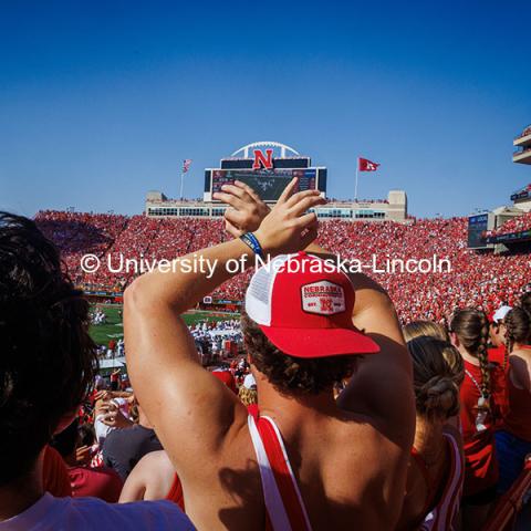 Carter Coulombe, a freshman Business Administration major, “throwing the bones” Nebraska vs Rutgers football game. Homecoming game. October 5, 2024. Photo by Kristen Labadie / University Communication.