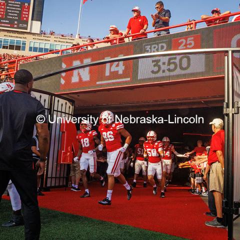 The football team charges onto the field during the tunnel walk at the Nebraska vs Rutgers homecoming football game. October 5, 2024. Photo by Kristen Labadie / University Communication.