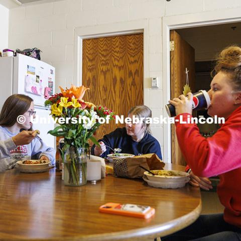 Breanna Gilmore, Sarah Dilley and McKenna Carr eat lunch together in their apartment that is part of the Animal Science building. Three student workers in the Animal Science building live in an apartment in the building. October 14, 2024. Photo by Craig Chandler / University Communication and Marketing.