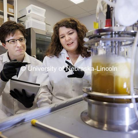 Nicole Buan, Professor in Biochemistry, and Connor Hines, graduate student in biochemistry, discuss the results of a biodigester experiment. Buan Laboratory in the Beadle Center. October 18, 2024. Photo by Craig Chandler / University Communication and Marketing.