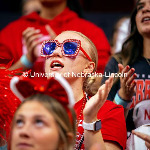 A student decked out in red rhinestone glasses celebrates at the Nebraska vs. Illinois Volleyball game. October 25, 2024. Photo by Kristen Labadie / University Communication.