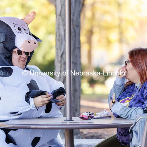 Vanessa Uriostegui (left), and Chelsea Lara sit outside the Nebraska Union. Halloween. Halloween on campus. October 31, 2024. Photo by Jordan Opp / University Communication and Marketing.