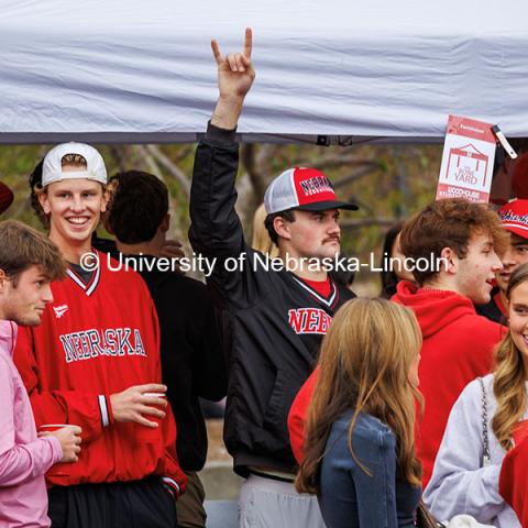 A student makes horns with his hand at the B1G Tailgate for the Nebraska vs UCLA football game. November 2, 2024. Photo by Kristen Labadie / University Communication.