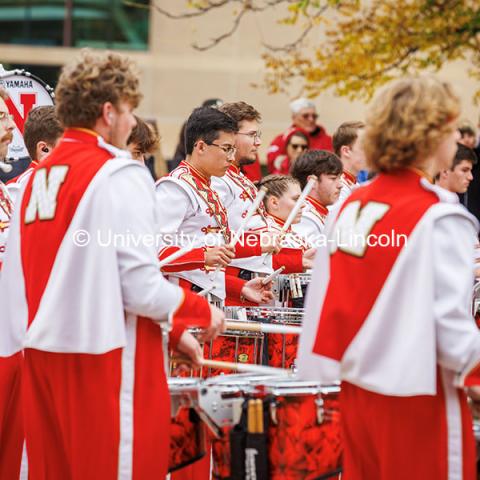 The Husker marching band drummers practice in front of the Sheldon Museum for the Nebraska vs UCLA football game. November 2, 2024. Photo by Kristen Labadie / University Communication.