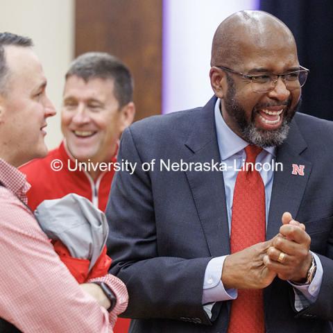 Chancellor Rodney Bennett, right, laughs as he talks to attendees of the Huddle Up Pre-Game Celebration inside the Nebraska Union Ballroom. Chancellor’s tailgate party.  November 2, 2024. Photo by Jordan Opp / University Communication and Marketing.