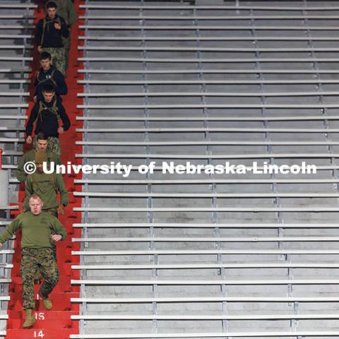 Captain Brian Garretson leads a group of NROTC members down a flight of stairs. Navy and Marine Corps 249th birthday celebration physical training in Memorial Stadium. November 8, 2024. Photo by Jordan Opp / University Communication and Marketing.