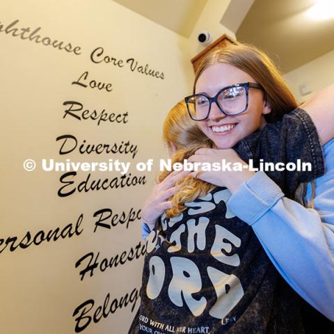 Alex Hughes, Lighthouse's volunteer and community outreach coordinator and UNL alumna, right, hugs Eleanor Wunderlich, 14, as she enters the building. The Lighthouse is an after-school program offering academic support and programming for middle and high school students. November 12, 2024. Photo by Jordan Opp / University Communication and Marketing.