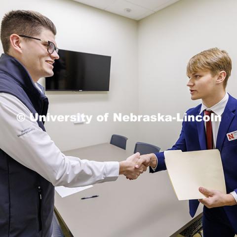 Junior Joshua Buhr, right, shakes hands with alum Parker Merwick during the final round. Fall 2024 Center for Sales Role-Play Competition. November 15, 2024. Photo by Jordan Opp / University Communication and Marketing.