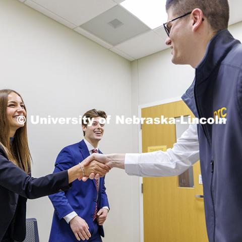 Kylie Eads and Aidan Kelch shakes hands with alum Parker Merwick at the conclusion of their meeting inside the College of Business. Fall 2024 Center for Sales Role-Play Competition. November 15, 2024. Photo by Jordan Opp / University Communication and Marketing.