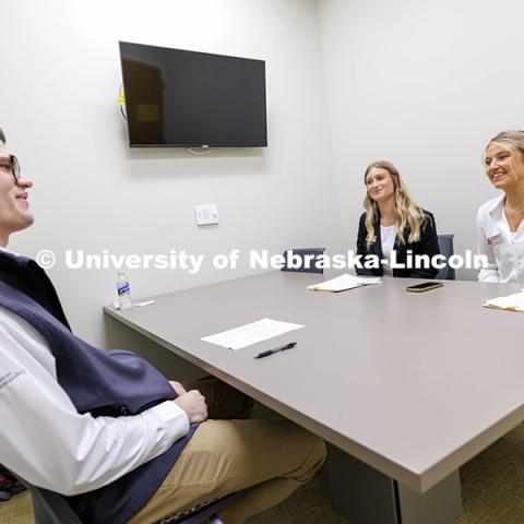 Kate Peterson and Charlie McCown sell their product to alum Parker Merwick inside the College of Business. Fall 2024 Center for Sales Role-Play Competition. November 15, 2024. Photo by Jordan Opp / University Communication and Marketing.