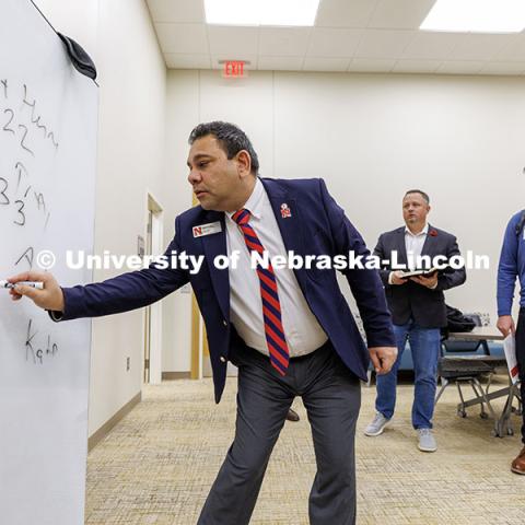 Robin Garewal, Assistant Professor of Practice in Marketing, tallies the judges votes to decide a winner. Fall 2024 Center for Sales Role-Play Competition. November 15, 2024. Photo by Jordan Opp / University Communication and Marketing.