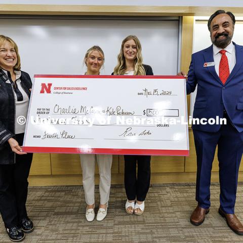 Charlie McCown and Kate Peterson, center, stand with their fourth-place check. Fall 2024 Center for Sales Role-Play Competition. November 15, 2024. Photo by Jordan Opp / University Communication and Marketing.