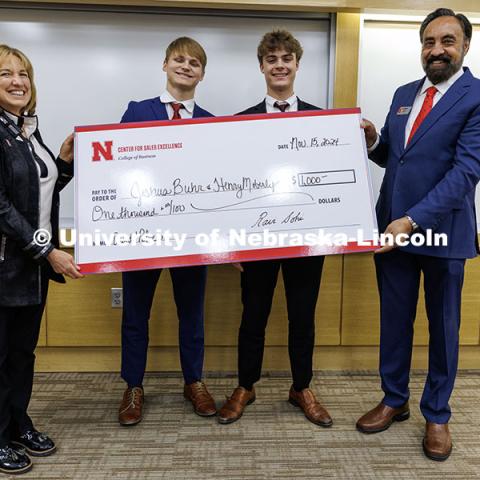 Joshua Buhr and Henry Moberly, center, stand with their third-place check. Fall 2024 Center for Sales Role-Play Competition. November 15, 2024. Photo by Jordan Opp / University Communication and Marketing.