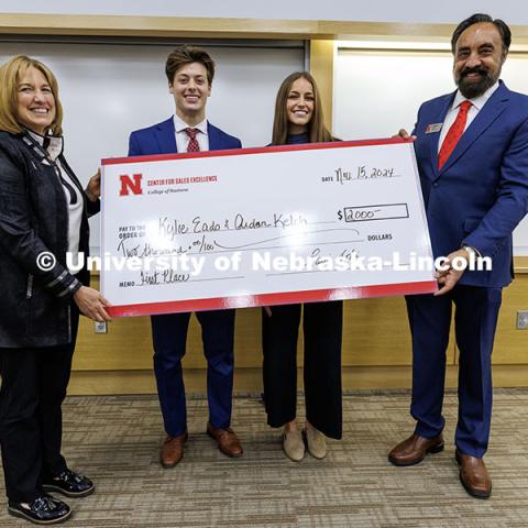 Kylie Eads and Aidan Kelch, center, stand with their first-place check. Fall 2024 Center for Sales Role-Play Competition. November 15, 2024. Photo by Jordan Opp / University Communication and Marketing.