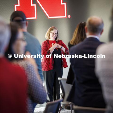 Sheri Jones, former Interim Vice Chancellor for Research and Innovation, Dean of the College of Education and Human Sciences, chair of the Department of Special Education and Communication Disorders and director of the Barkley Memorial Center for seven years, and lifelong Husker acknowledges a standing ovation given her at her retirement reception. November 15, 2024. Photo by Craig Chandler / University Communication.