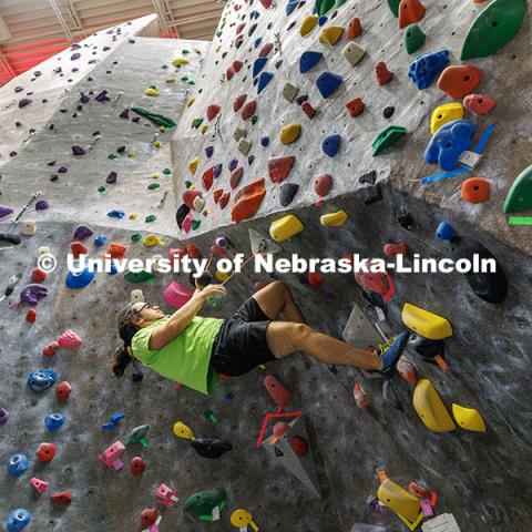 Aaron Sanchez, junior, goes parallel with the wall as he works to climb up in the Campus Recreation facility on City Campus. The League of Extraordinary Boulderers program is designed to teach participants climbing techniques and build friendships with others interested in bouldering. November 20, 2024. Photo by Jordan Opp / University Communication and Marketing.