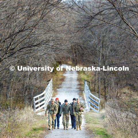 Army ROTC cadet Joe Wiese (from left), Nebraska National Guard member Cory Zelfel, cadet Malorie Mulligan, UNL Student Veterans of America treasurer Brett Klein, and cadet Max Holmstrom walk along the Missouri Pacific Trailhead near Wabash. Ruck March. November 21, 2024. Photo by Jordan Opp / University Communication and Marketing.