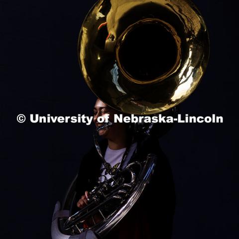 A member of the Cornhusker Marching Band carries their sousaphone and smiles as they walk out of Memorial Stadium. Nebraska vs. Wisconsin football game. November 23, 2024. Photo by Jordan Opp / University Communication and Marketing.