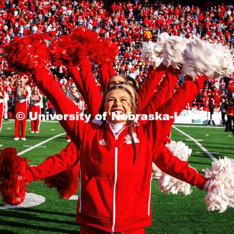 Danielle Blum, a junior graphic design major and Husker Cheerleader stands in front of the group of cheerleaders performing during the pre-game festivities at the Huskers vs. Wisconsin football game. November 23, 2024. Photo by Kristen Labadie / University Communication.