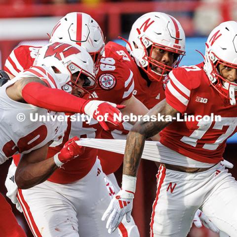 Wide receiver Jacory Barney Jr. (17) has his shirt pulled as he runs after catching the football for a first down. Nebraska vs. Wisconsin football game. November 23, 2024. Photo by Jordan Opp / University Communication and Marketing.