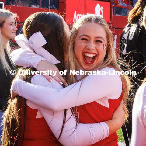 Haili Foster, a sophomore Husker Cheerleader, hugs her friend on the cheer squad after performing a successful cheerleading stunt. November 23, 2024. Photo by Kristen Labadie / University Communication.