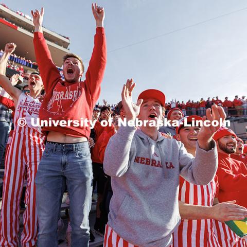 Tom Dey, right, cheers alongside other Nebraska fans after a big opening kickoff return. Nebraska vs. Wisconsin football game. November 23, 2024. Photo by Jordan Opp / University Communication and Marketing.