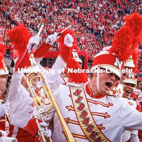 A band member cheers while waiting to perform during halftime at the Huskers vs. Wisconsin football game. November 23, 2024. Photo by Kristen Labadie / University Communication.