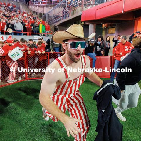 Husker fans storm the field following the team’s 44-25 win over Wisconsin to secure bowl game eligibility. Nebraska vs. Wisconsin football game. November 23, 2024. Photo by Jordan Opp / University Communication and Marketing.