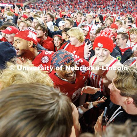 Husker fans storm the field following the team’s 44-25 win over Wisconsin to secure bowl game eligibility. Nebraska vs. Wisconsin football game. November 23, 2024. Photo by Jordan Opp / University Communication and Marketing.