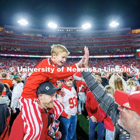 Husker fans storm the field following the team’s 44-25 win over Wisconsin to secure bowl game eligibility. Nebraska vs. Wisconsin football game. November 23, 2024. Photo by Jordan Opp / University Communication and Marketing.