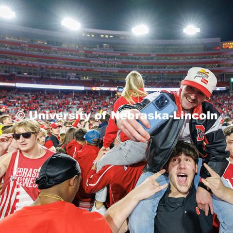 Husker fans storm the field following the team’s 44-25 win over Wisconsin to secure bowl game eligibility. Nebraska vs. Wisconsin football game. November 23, 2024. Photo by Jordan Opp / University Communication and Marketing.