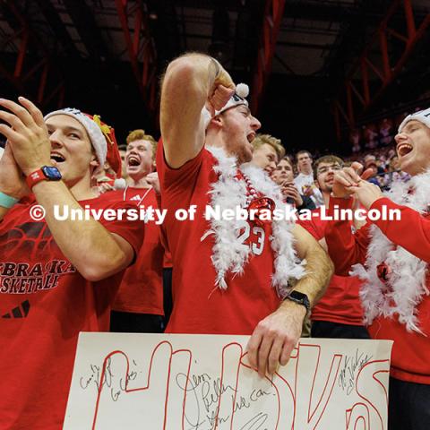 Bodie True (from left) Jacob Imig, and Andrew McNamara cheer on the Husker volleyball team during round one of the NCAA Volleyball Tournament at the Bob Devaney Sports Center. Nebraska vs. Florida A&M Volleyball game. Photo by Jordan Opp / University Communication and Marketing.