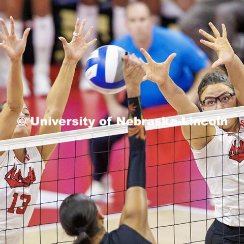 Nebraska’s Merritt Beason (left) and Rebekah Allick (right) attempt to block the ball during round two of the NCAA Volleyball Tournament at the Bob Devaney Sports Center. Nebraska vs. Miami Volleyball game. Photo by Jordan Opp / University Communication and Marketing.