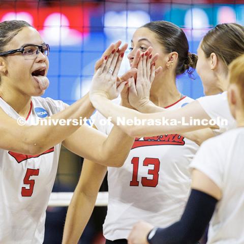 Nebraska’s Rebekah Allick (left) sticks her tongue out after scoring a point during round two of the NCAA Volleyball Tournament at the Bob Devaney Sports Center. Nebraska vs. Miami Volleyball game. Photo by Jordan Opp / University Communication and Marketing.