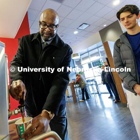 Chancellor Rodney Bennett, left, serves coffee to students inside the Nebraska Union. Finals Fuel. December 16, 2024. Photo by Jordan Opp / University Communication and Marketing