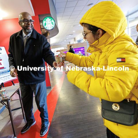 Chancellor Rodney Bennett, left, serves coffee to students inside the Nebraska Union. Finals Fuel. December 16, 2024. Photo by Jordan Opp / University Communication and Marketing