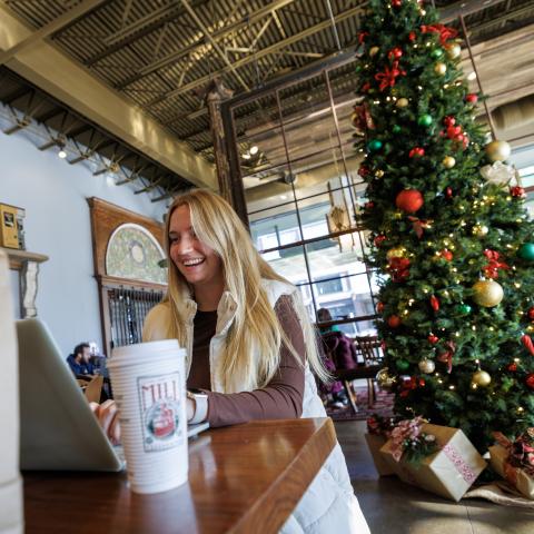 Elsa Wilcox, a senior speech-language pathologist major, studies for her speech sound disorders final inside The Mill at Nebraska Innovation Campus. December 18, 2024. Photo by Jordan Opp / University Communication and Marketing.